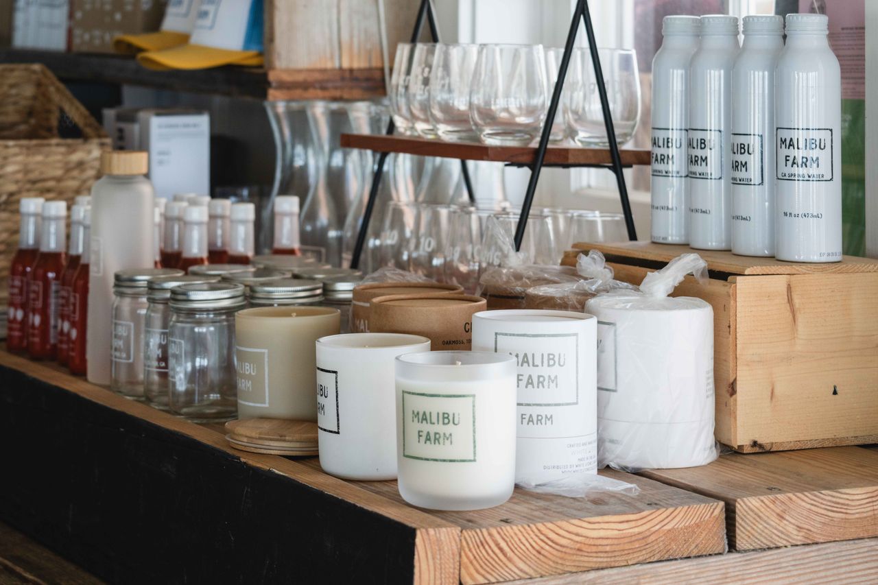 about-hero Explore the cozy rustic charm of Malibu Farm store showcasing organic products and chic decor.